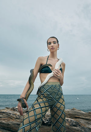 Hand-embroidered on pastel olive green net, the sheer pant features criss-cross embroidery pattern playing with different sequin sizes and colors in green. This transparent pant fall straight to floor from the high-waist. 