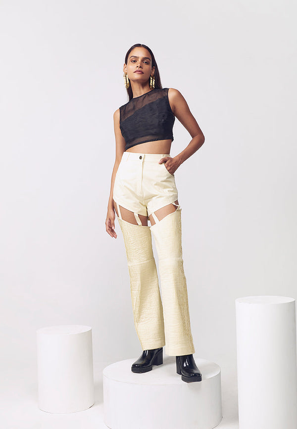 Level up your style with these buttercream combat-inspired straight, detachable pants crafted in cotton twill which make the pants smooth and comfortable. These pale yellow pants sit high on the waist and fall straight to the floor. These pleated straight pants can be transformed to a pair of shorts by using the buttons hidden around the thigh for detachable function. Pair these cut-out pants with a crop top