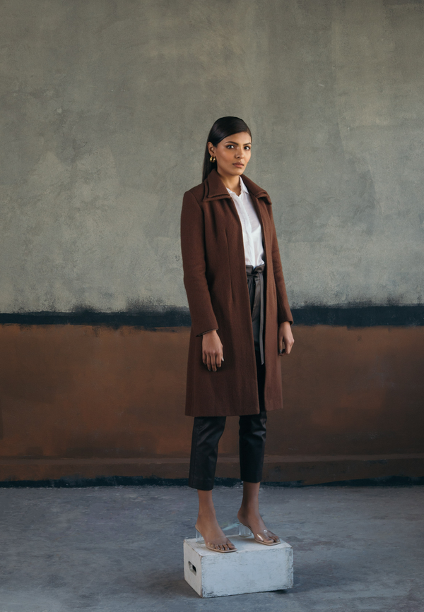 This woman’s brown double collared wool coat is chic and versatile. Crafted from plush wool, the wool jacket features a double collar with princess lines in the front for a more fitted look. This knee-length coat is a definite style statement for the winters. The easy and comfortable fit on the front make it perfect and versatile for layering over anything.
