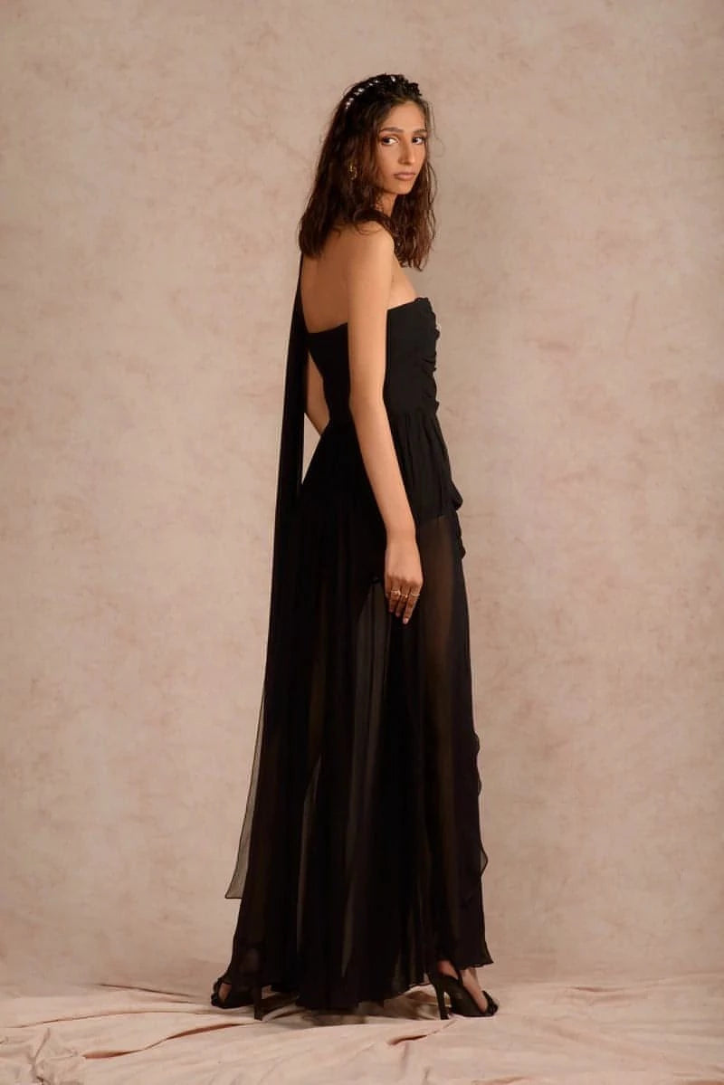 Beautiful women’s maxi for your next soirée. This sheer one-shoulder draped maxi dress with thigh-high slit is cut from pure georgette in black. The ruching on the bodice adds texture to the piece while making the piece flattering on all body types. Bodysuit attached inside the dress for comfort and coverage. It is the perfect dress for your next date or formal evenings/dinners.