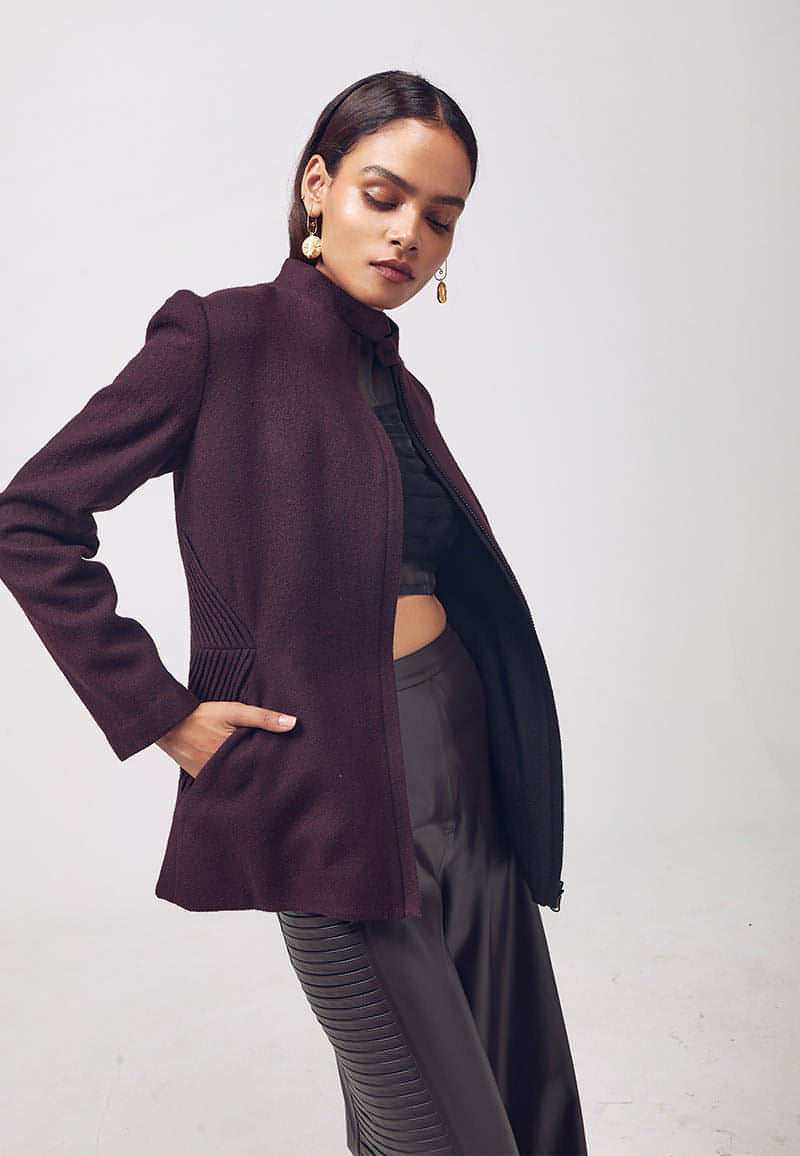 Mannat Gupta's elegant collection of women's jackets and coats. Add functionality and versatility in your wardrobe with this reversible wool coat which is perfect for the breezy, spring, fall and winter season. The wool coat comes with a reversible zip and can be worn in two colors, black and wine. It features a Chinese collar, slash pockets on both sides and long sleeves for coverage and comfort.