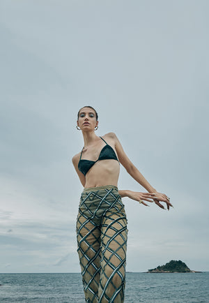 Hand-embroidered on pastel olive green net, the sheer pant features criss-cross embroidery pattern playing with different sequin sizes and colors in green. This transparent pant fall straight to floor from the high-waist. 