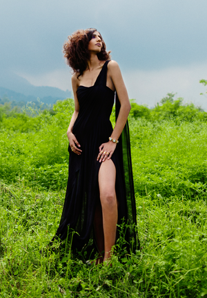 Beautiful women’s maxi for your next soirée. This sheer one-shoulder draped maxi dress with thigh-high slit is cut from pure georgette in black. 