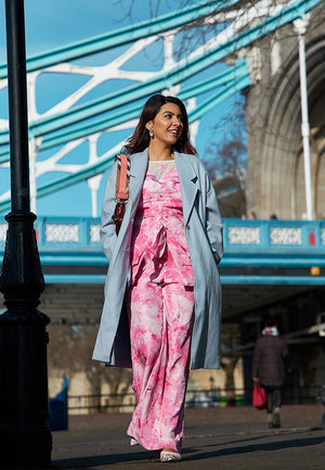 This beautiful tie-dyed high-waisted pants made from lustrous silk is sure to grab attention. Wear it in the summers, spring or fall for its tonal pink and white hues. Skirt and flap pockets in the front is highlight of the ensemble. These pants are perfe