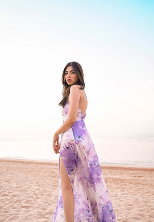 Women's new purple and white printed long maxi dress is made from airy sheer chiffon. This floor-length tie-dye dress is perfect for summer days and parties at the beach. The maxi features a plunging neckline on the front and a crossback neckline on the b