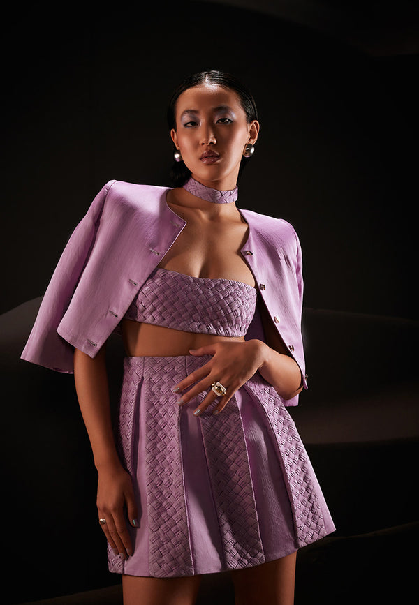 This beautifully handcrafted 3-piece co-ord set is designed to create an impact wherever you go. It features a weaved bandeau top, high-waisted box pleated skirt accompanied with a short jacket with a round neckline in pastel violet offering a flawless and tempting look. The ensemble is cut from hand-dyed linen satin fabric giving it a luxurious and comfortable look. Pair yours with strappy sandals and gold jewellery to amplify the look.