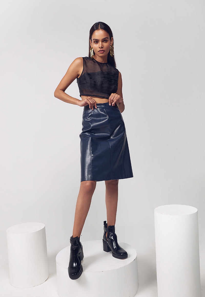 Best quality artificial leather midi skirt for women,which is favoured for its softness and clean glossy finish and echoing the designer's commitment to more ecological practices. This navy blue faux leather straight skirt features princess lines on both sides along with a concealed zip for closure. The skirt falls to the knee and is high-waisted. Pair yours with booties or thigh-high boots alone with a bodycon sweater or top with minimal gold jewelry to complete the look. 