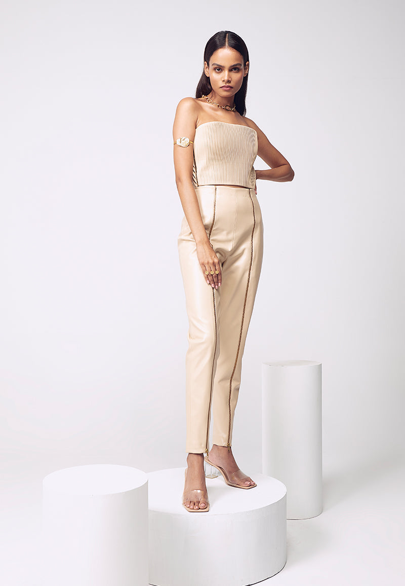 The perfect high-waisted slim cigarette fit pants for your next vacation or party in the city - Mannat Gupta’s ankle-length leather pants with zipper slits giving an amazing appeal to every woman’s body. You can pair this up with our leather crop top or bustier with heeled sandals to complete the look.