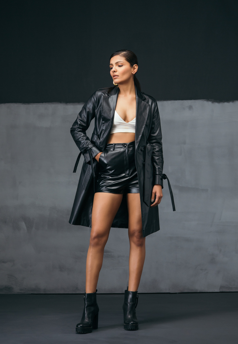 Get ready for the perfect party look with Mannat Gupta’s collections of leather jackets. It is impossible not to feel uplifted in artificial leather wrap jacket thanks to its bold black hue. It is tailored from faux leather and falls above the knees and has a adjustable belt strap on waist. Feel confident with tie details around the wrists and leather buttons for closure. Pair with knee-length boot or booties over a dress or top and pants to complete your look for the night.