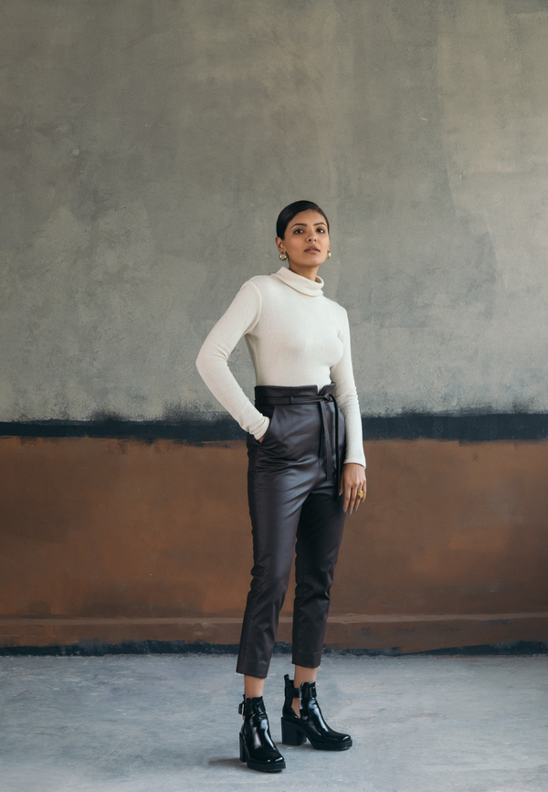 These women’s ankle length artificial leather pants in brown is a fall and winter essential. Crafted from supple faux leather, these high-waisted cigarette pants are sleek with a leather belt on the waist. Style these modern, minimal brown cigarette pants with a timeless white shirt for formal, work look or an embroidered top or corset for evening parties.
