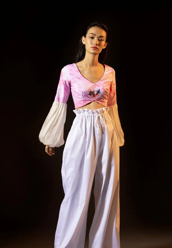 Mannat Gupta's new style crop top for women with pleated sleeves, this crop top is made from airy cotton with tie dye print in pink and white. The chiffon balloon sleeves in white are carefully pleated for an effortless and comfortable summer look. Pair it with baggy pants or jeans and sneakers or heels to complete the look.
