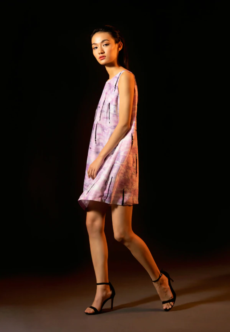 Versatile and minimal dress collection from Mannat Gupta which every woman will love to have. You can style in this beautiful embellished short A-line dress which is made of luxe silk and printed with a purple tie-dye pattern. This flared mini dress is crafted with black sequins. Pair this sleeveless mini dress with heeled sandals and minimal jewelry for your next night out.