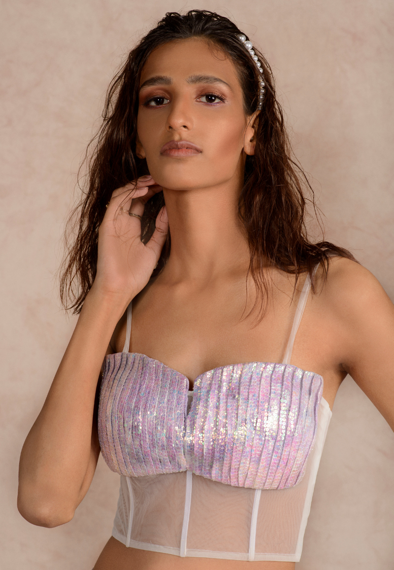 Add a touch of glamour with this purple dye print pleated bustier made from silk. The net details and the sequin work enhances the ensemble. Pair it with our silk maxi skirt or trousers to be a scene stealer. An easy-wear ensemble in summers and autumn.