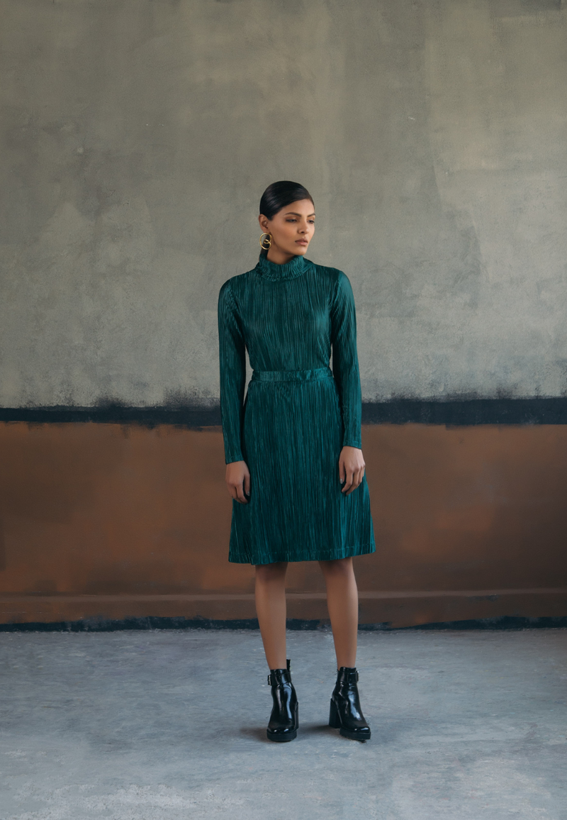This bottle-green co-ord set in pre-pleated jersey knit fabric of the high-neck top and midi flared skirt is a must-have for spring or summers. This style features an invisible zipper on the side. Wear it with high heels to dinners or parties and you are sure to grab attention.