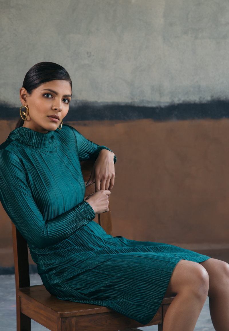 This bottle-green co-ord set in pre-pleated jersey knit fabric of the high-neck top and midi flared skirt is a must-have for spring or summers. This style features an invisible zipper on the side. Wear it with high heels to dinners or parties and you are sure to grab attention.