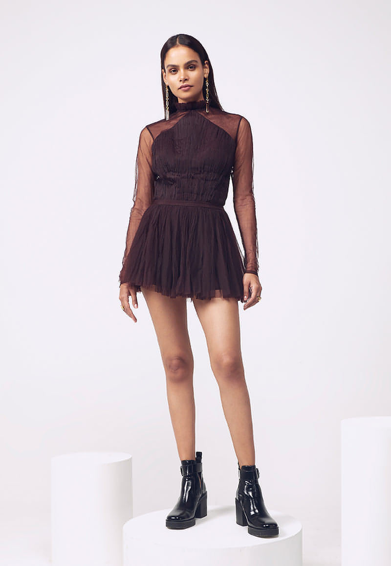 Mannat Gupta’s bodysuit in wine is crafted using lush net with intricate and minimal ruching detail. The transparent/sheer back and ruched detail around the neck gives the wearer an alluring effect. Pair it with our ruffled mini skirt and detachable trail to add glamour. Perfect outfit inspiration for any gathering in the summers or winters. Or pair the maroon bodysuit with  jeans or trousers for a more casual, comfortable and everyday look.