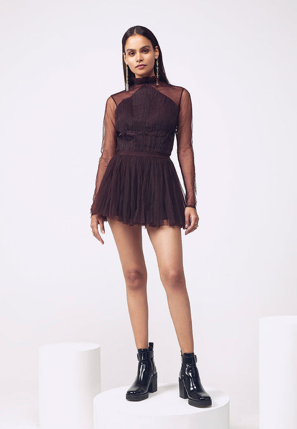 This detachable wine ruffled gown is modernized through an intriguing juxtaposition of layers and transparencies that gives it an ethereal feel. This expertly crafted ensemble with a special layered ruched detachable trail, ruched bodysuit and gathered mini skirt is versatile. The bodysuit can be worn separately with a pair of jeans or pants and the mini skirt can be paired with a corset, bustier or a bodycon top. 