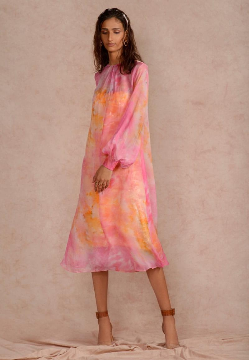 This pink and yellow sheer  dye print midi dress with a  sequin dress underneath can be styled in multiple ways. Made in chiffon and crepe this ensemble with handcrafted bandeau is perfect for the next date or formal evenings. Wear the piece in summer or style it in winter with an overlap jacket and stylish boots