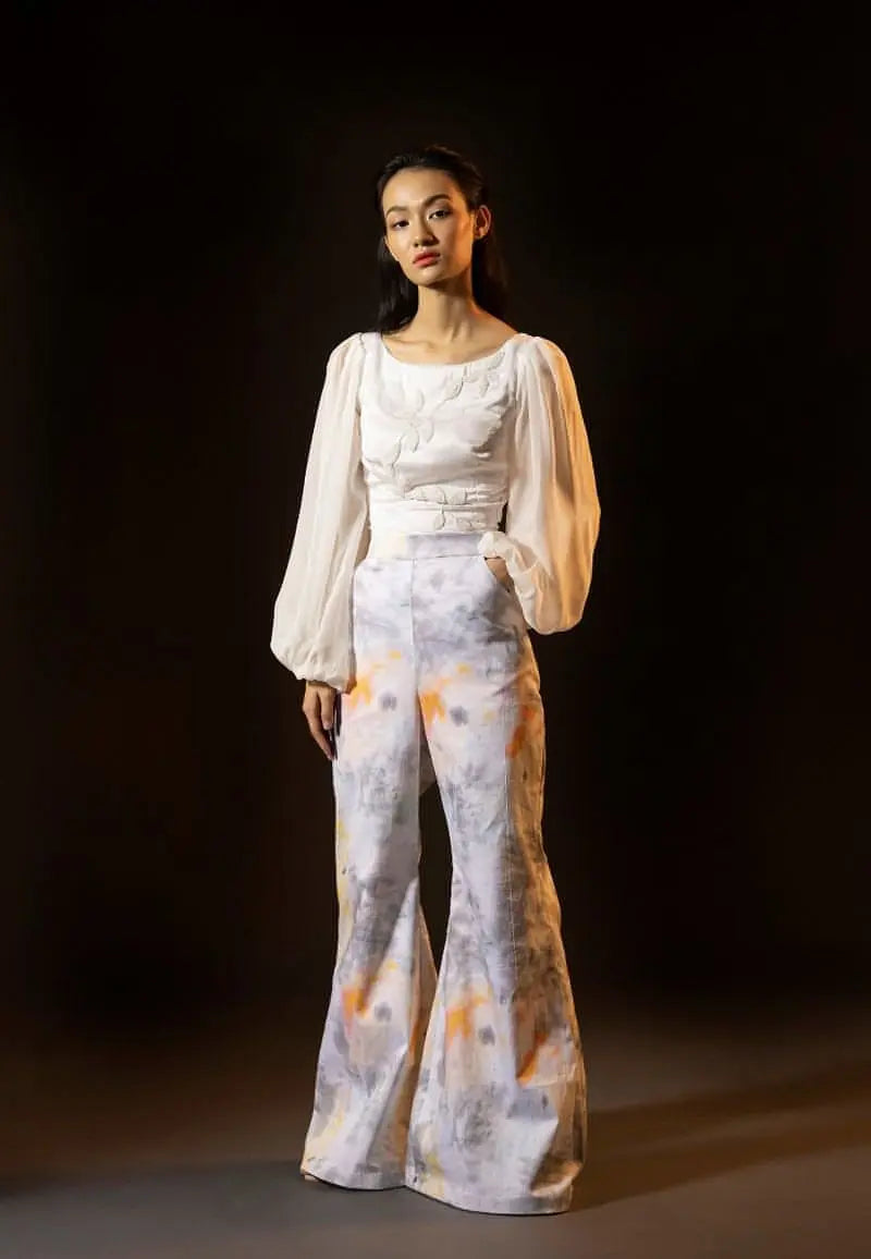Effortlessly styled these high-rise waist pants with tie-dye print is a must have for the summers. Slip into this comfortable grey yellow ensemble made in cotton. Pair it with our embroidered white top or corset along with minimal gold jewellery and you are good to go.