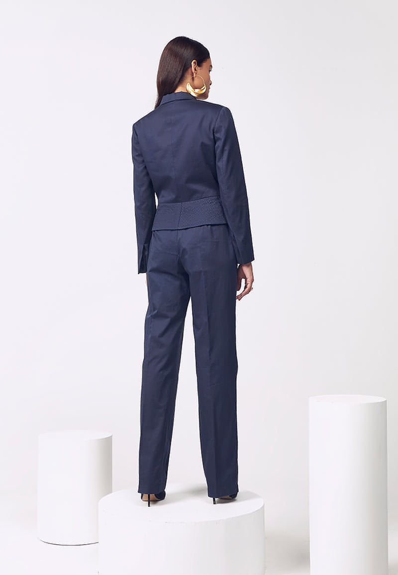 Mannat Gupta's premuim collection of women's co-ord sets. This jacket and pant co-ord set is made is soft cotton satin in navy blue. The collared cropped jacket with hidden buttons on the front features long sleeves and hand pleating details on both sides that accentuate a woman's body. The navy blue jacket comes with a high-waisted flared pant with inseam pockets for functionality in the same color. Pair yours with pumps and minimal, versatile gold jewelry for your next meeting or work.